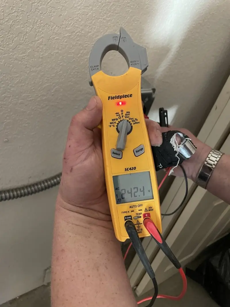 Voltage testing with clamp meter during Outlet Installation in Quail Ridge